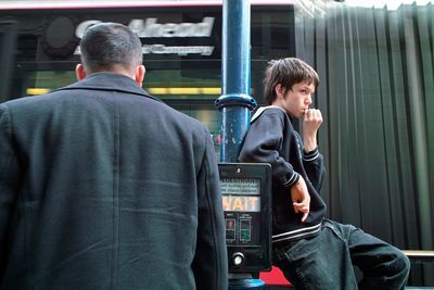 Boy waits. Passing tram