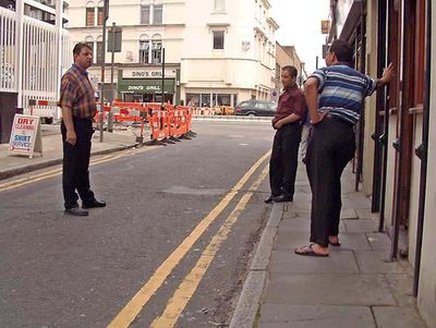 Three men chatting in the street
